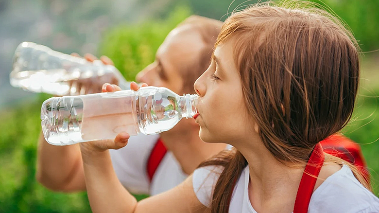 image of two young persons drinking from water bottles